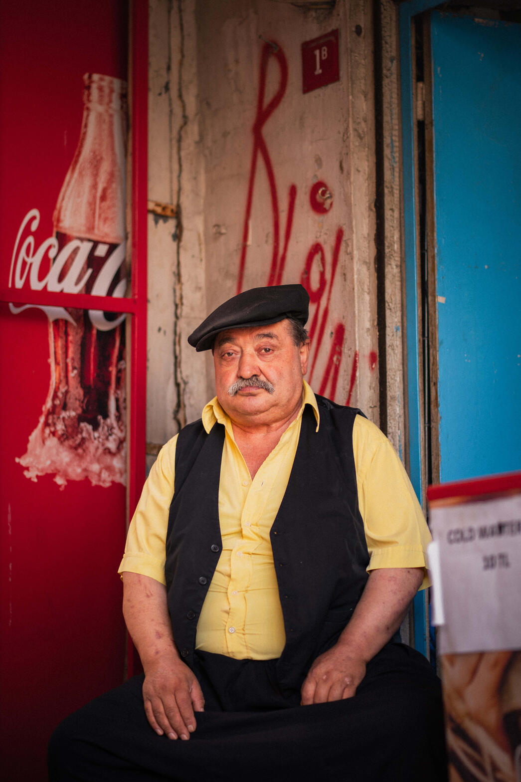 Ruling the Shop — A stylish local Turkish man in front of his shop. I noticed that he wasn't distracted by all the noise around him. He was contained, calm, and smiling. Even when I asked him to make a portrait, he barely nodded with a smile on his face.