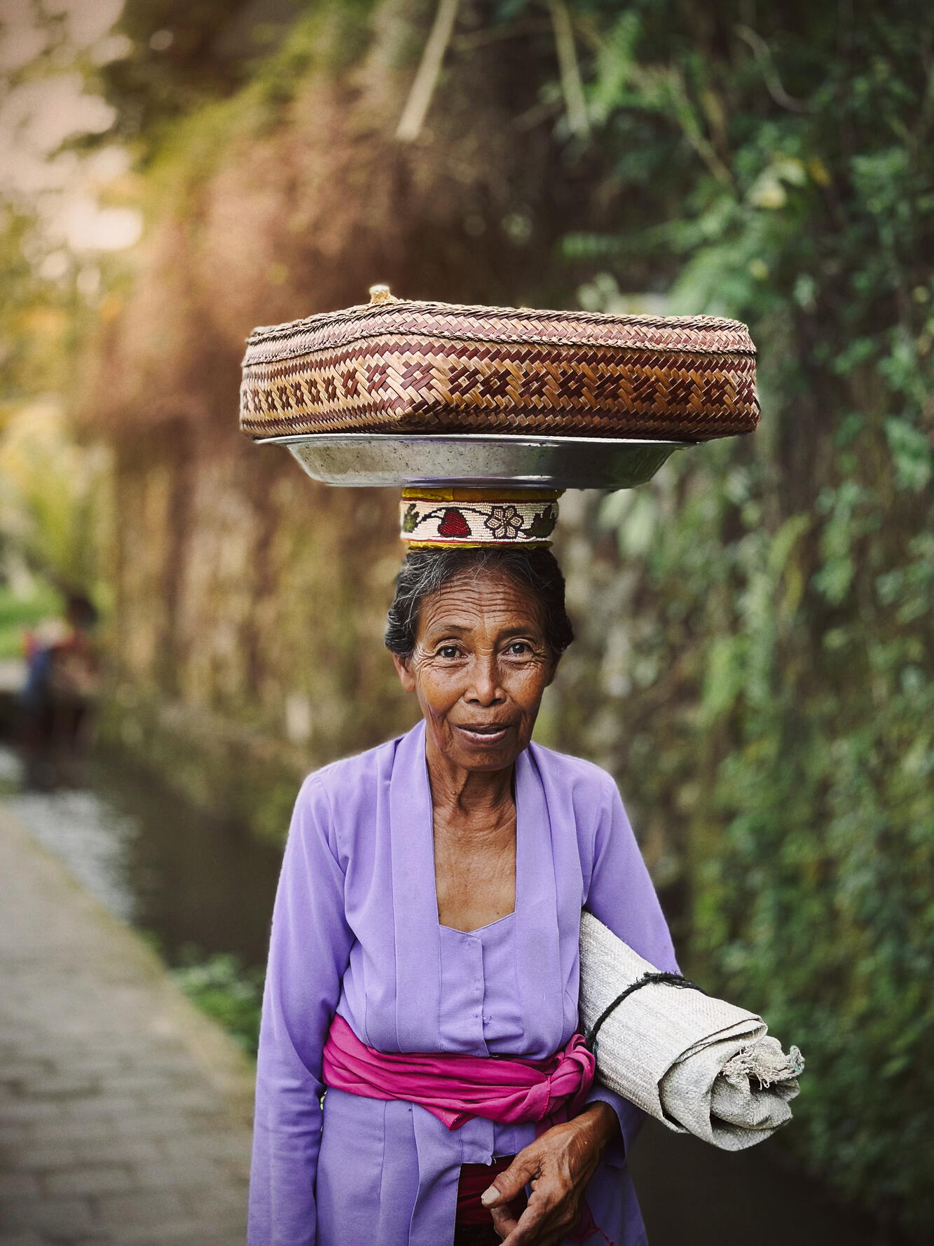 Balinese Woman — In early mornings, I'd encounter people who work in the rice fields, right next to their homes. Peaceful and very positive people. You'd witness the power from their skin and the determind eyes.